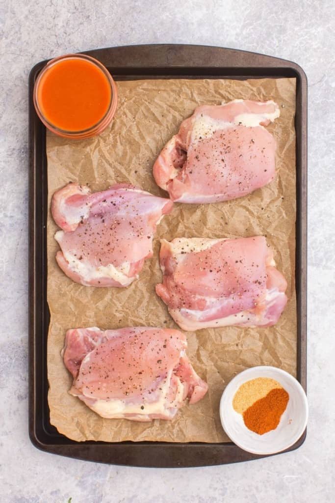 ingredients for buffalo chicken thighs on cutting board