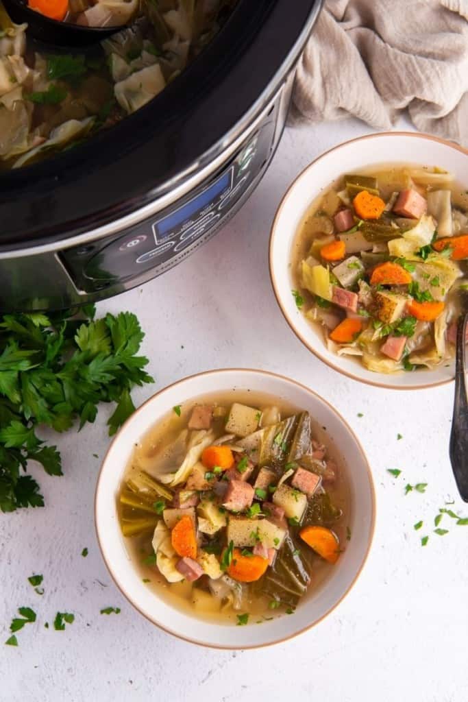 bowls of crockpot ham and cabbage soup