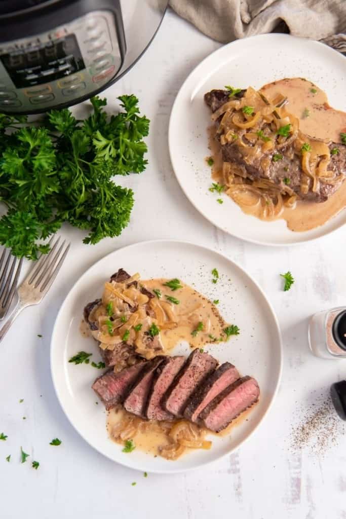 slices of instant pot steak with sauce on the side
