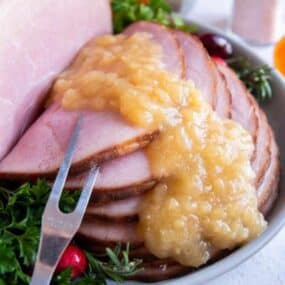 Pineapple sauce drizzled over glazed ham slices