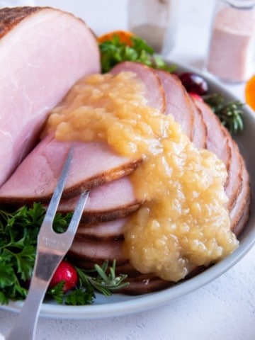 Pineapple sauce drizzled over glazed ham slices