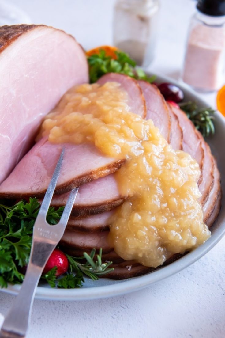 Pineapple sauce drizzled over glazed ham slices
