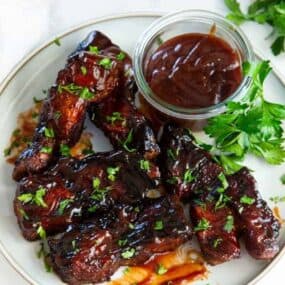 Ribs reheated in air fryer on a plate with dipping sauce