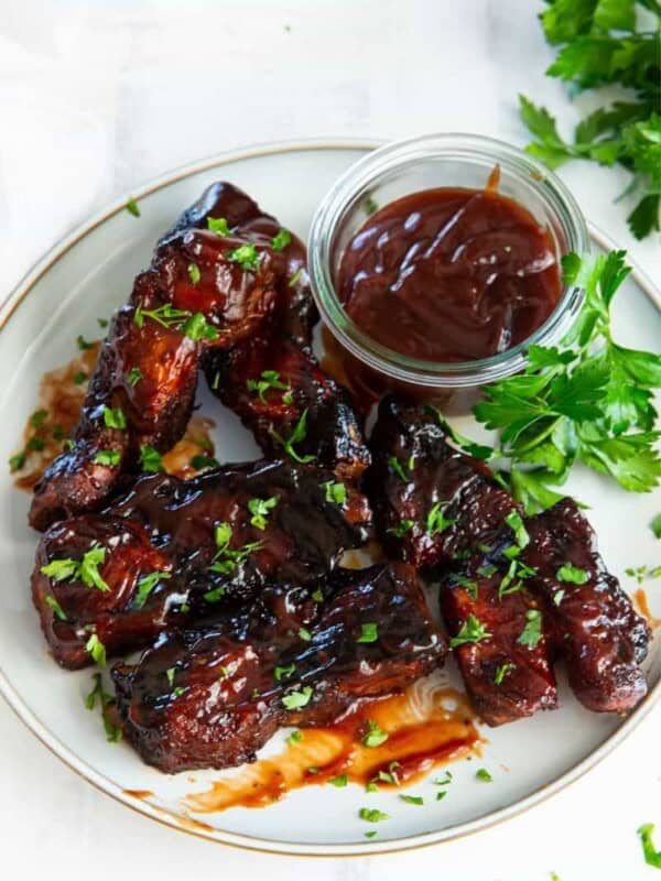 Ribs reheated in air fryer on a plate with dipping sauce