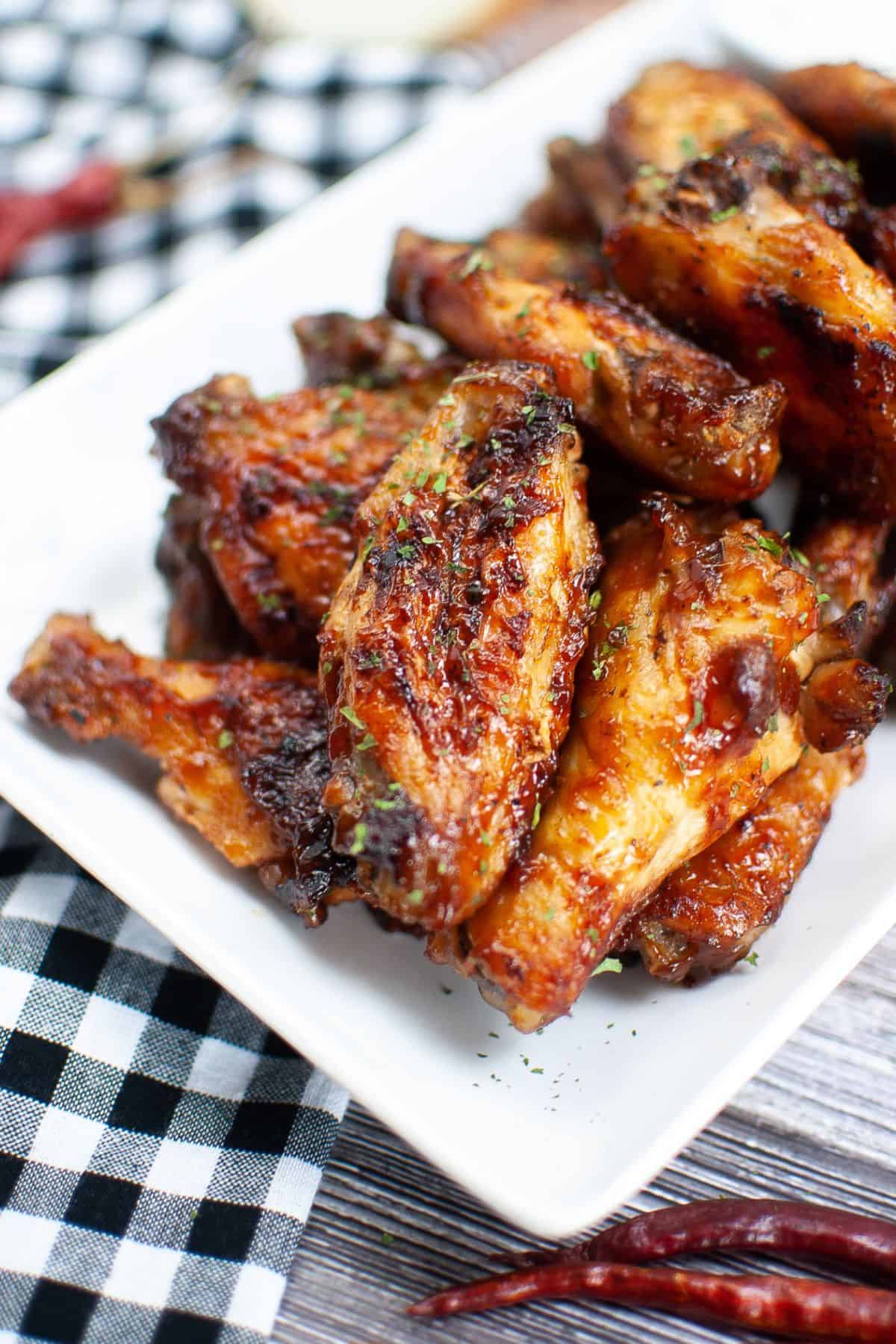 Plated air fryer bbq chicken wings on a rectangular white serving plate.