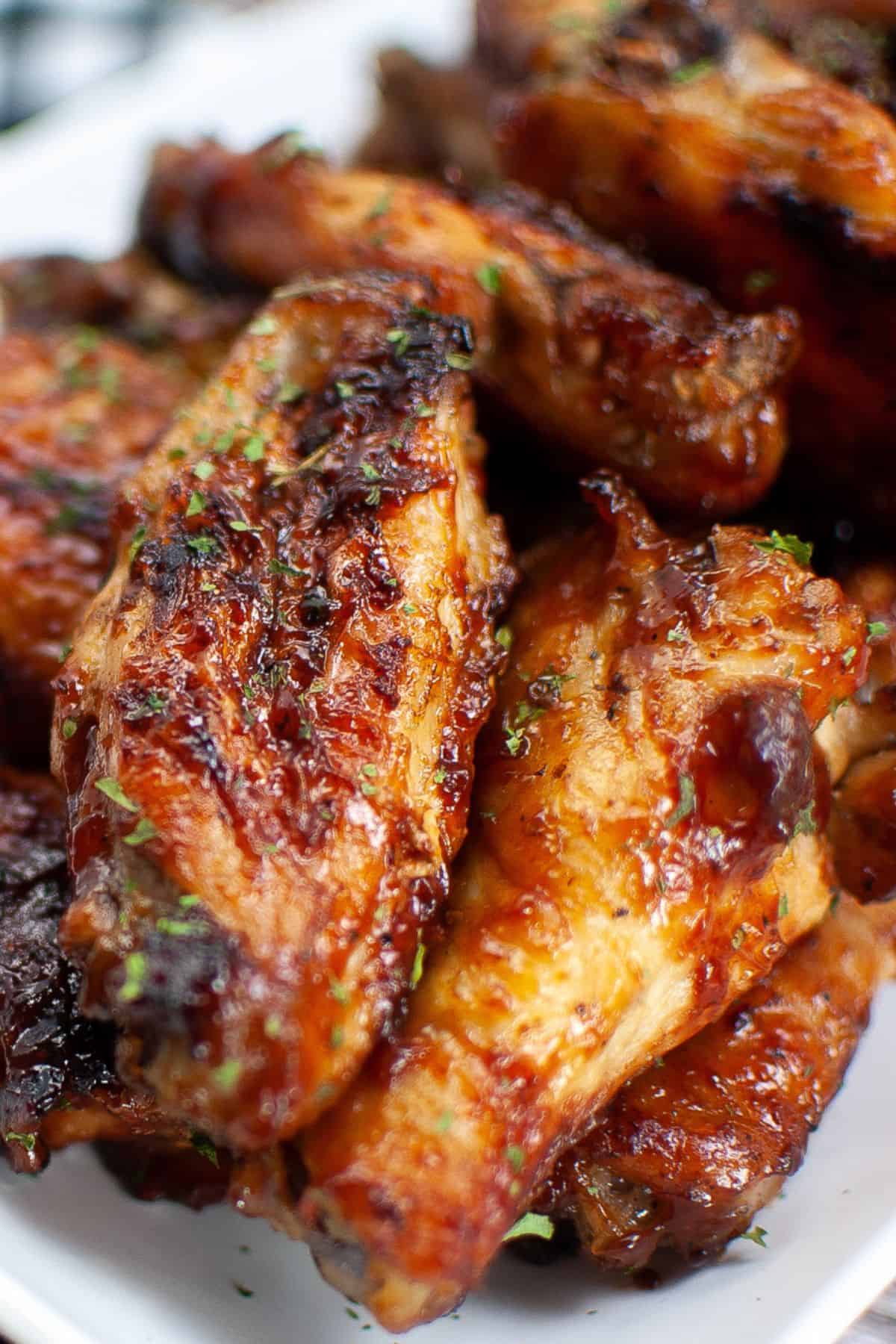 Close up of the air fryer chicken wings with BBQ sauce on them.