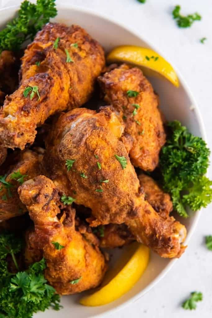 air fryer fried chicken tenders on plate with garnishes