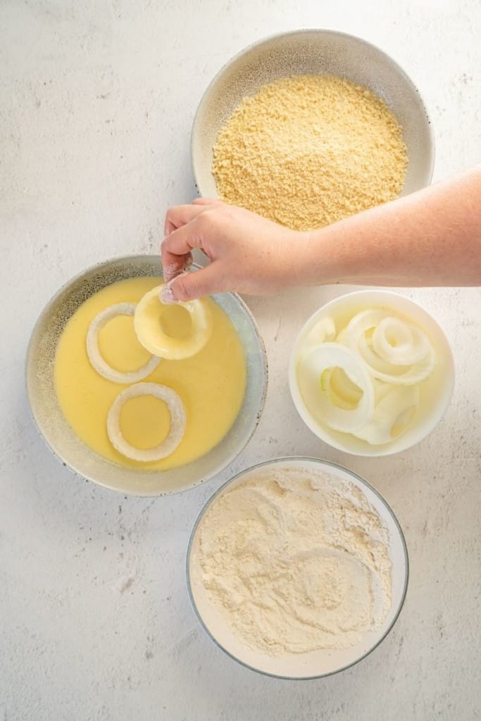 dip onion rings into flour and buttermilk mixtures