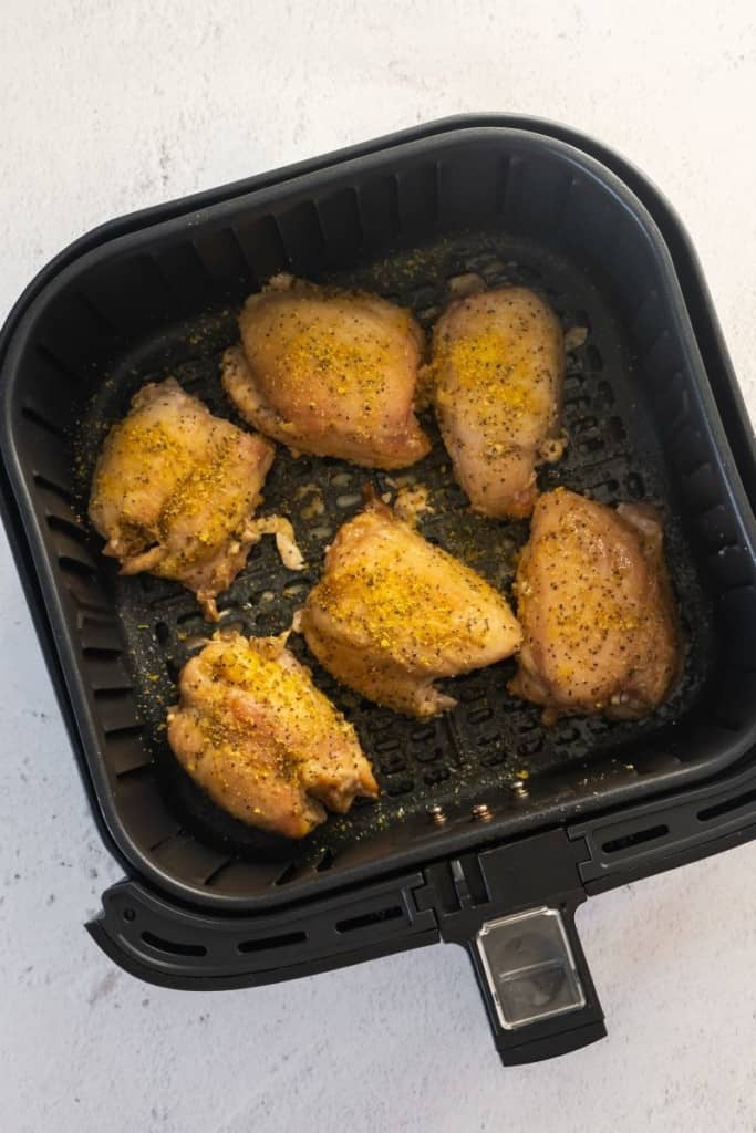 season chicken thighs and cook in air fryer