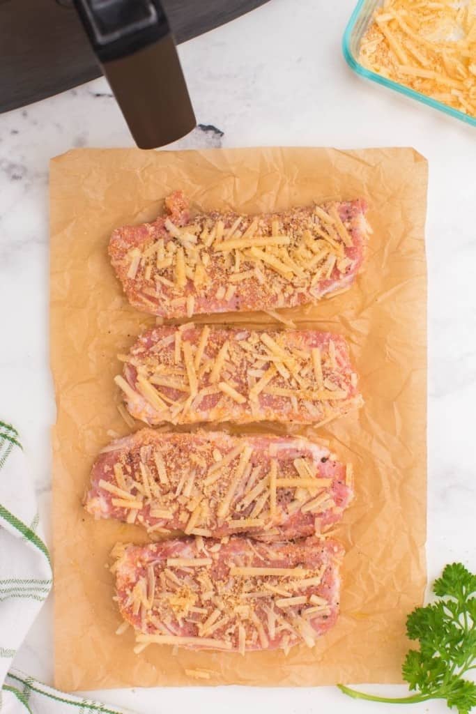 coat pork chops in parmesan cheese and seasonings