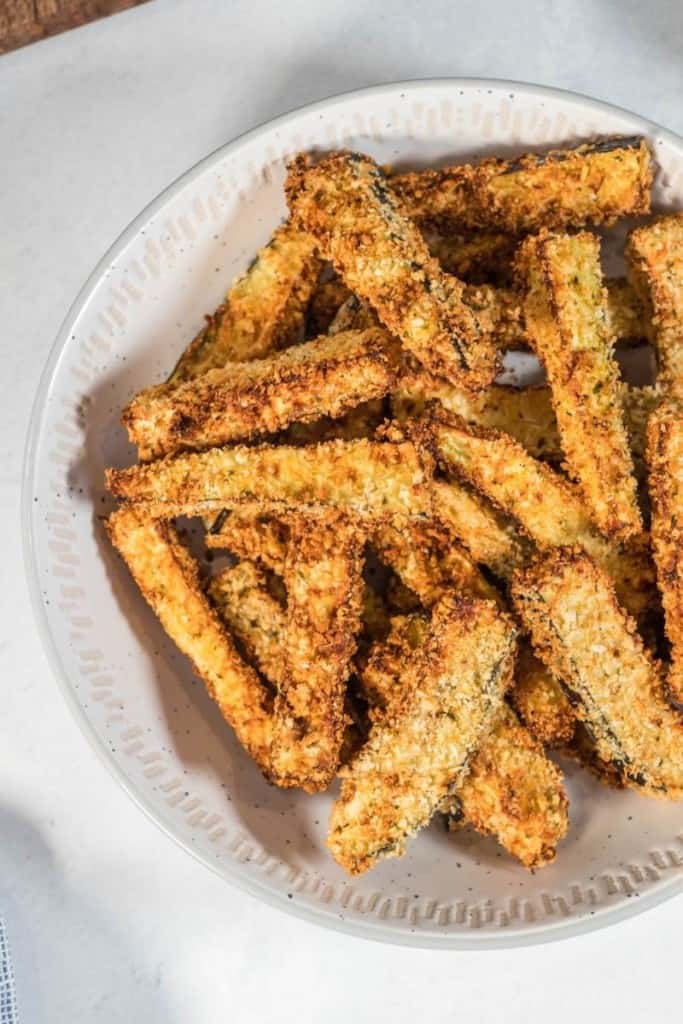 white plate with air fryer eggplant fries
