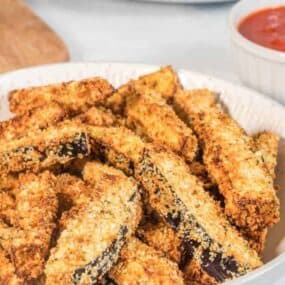 Full plate of breaded eggplant fries from air fryer