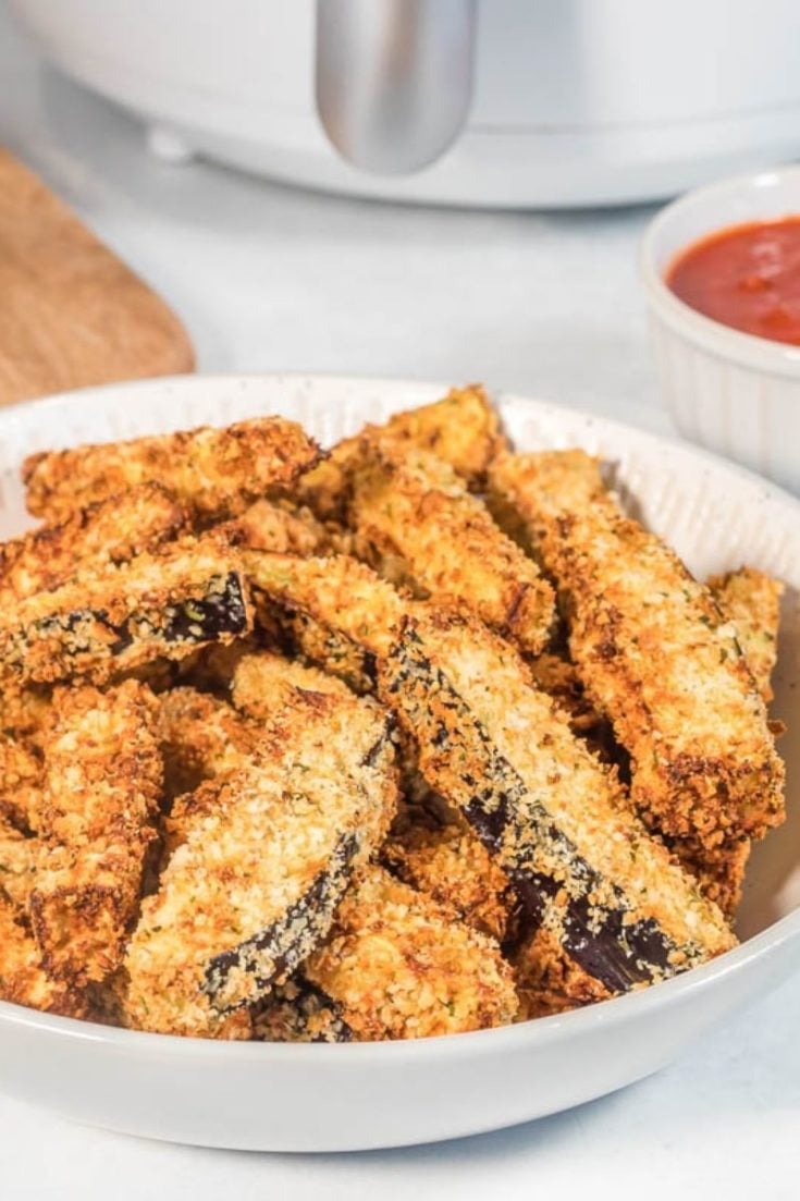 Full plate of breaded eggplant fries from air fryer