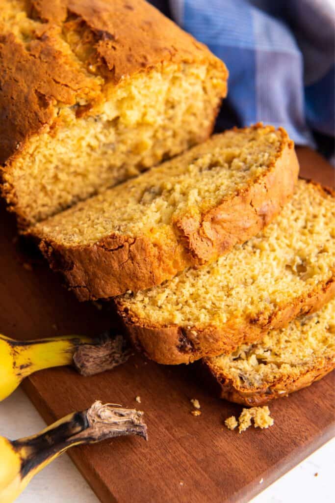 Banana bread using cake mix sliced on a cutting board so you can see the inside.