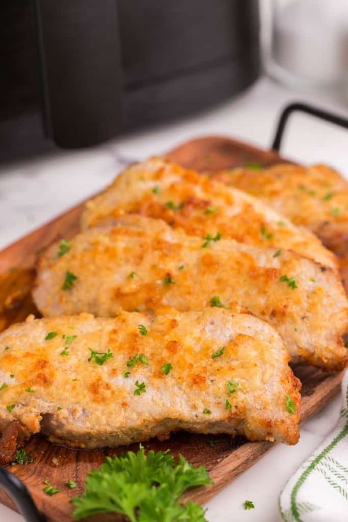 boneless pork chops cooked in air fryer on cutting board