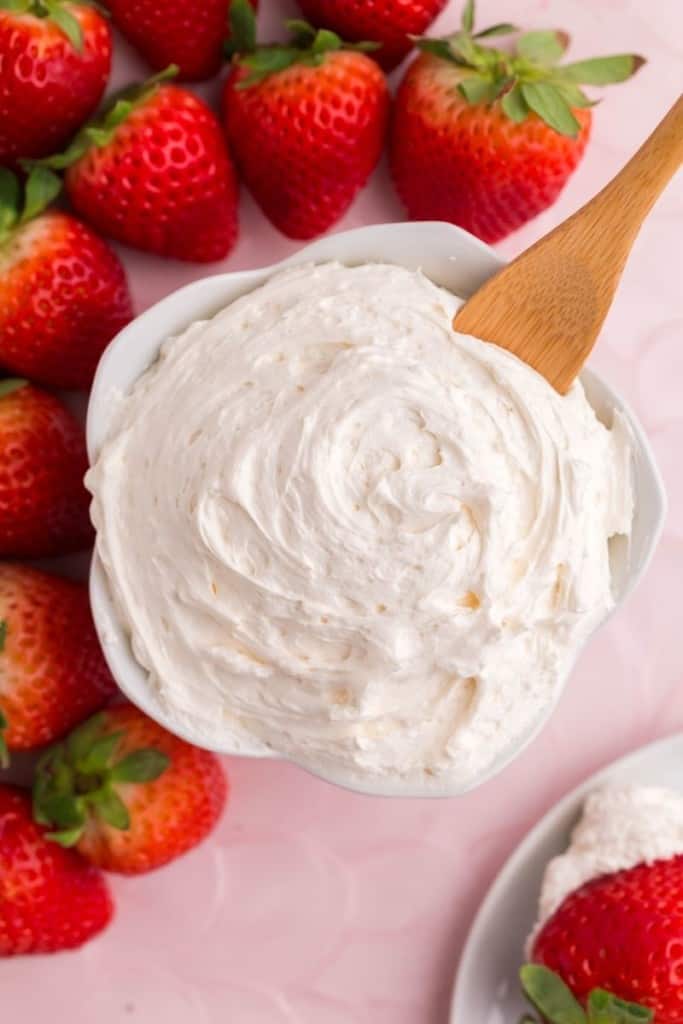 cool whip fruit dip in bowl with serving spoon