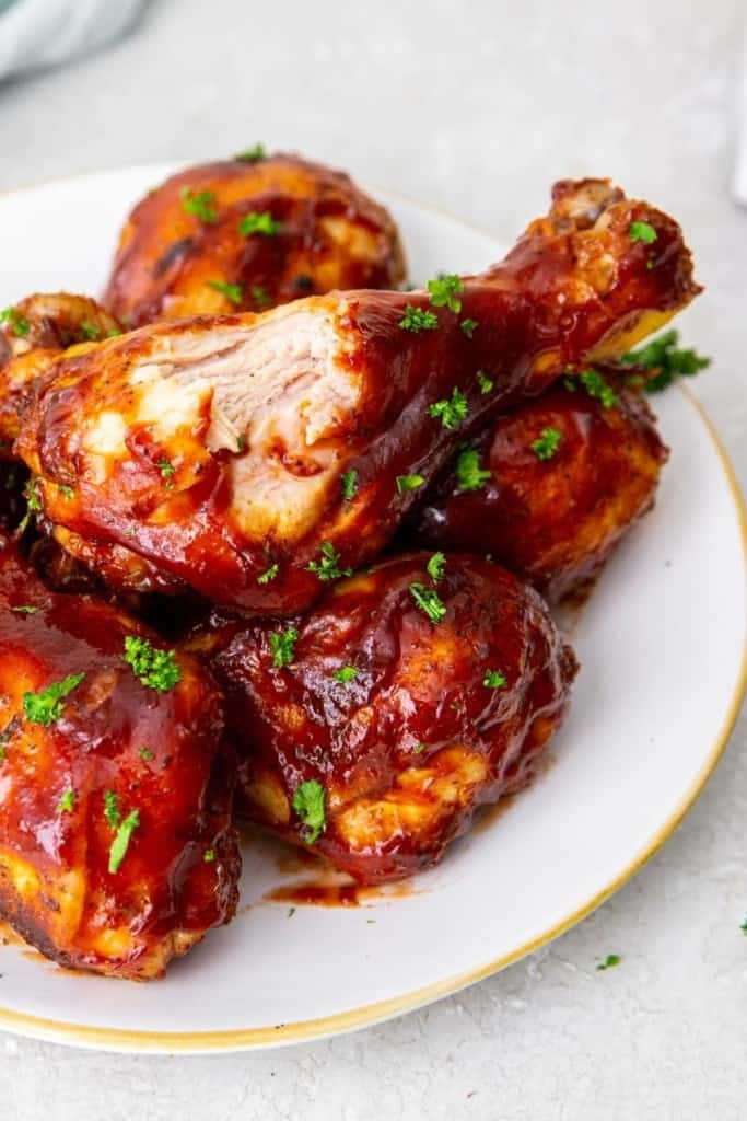 instant pot chicken drumsticks on plate with bite taken out of one drumstick