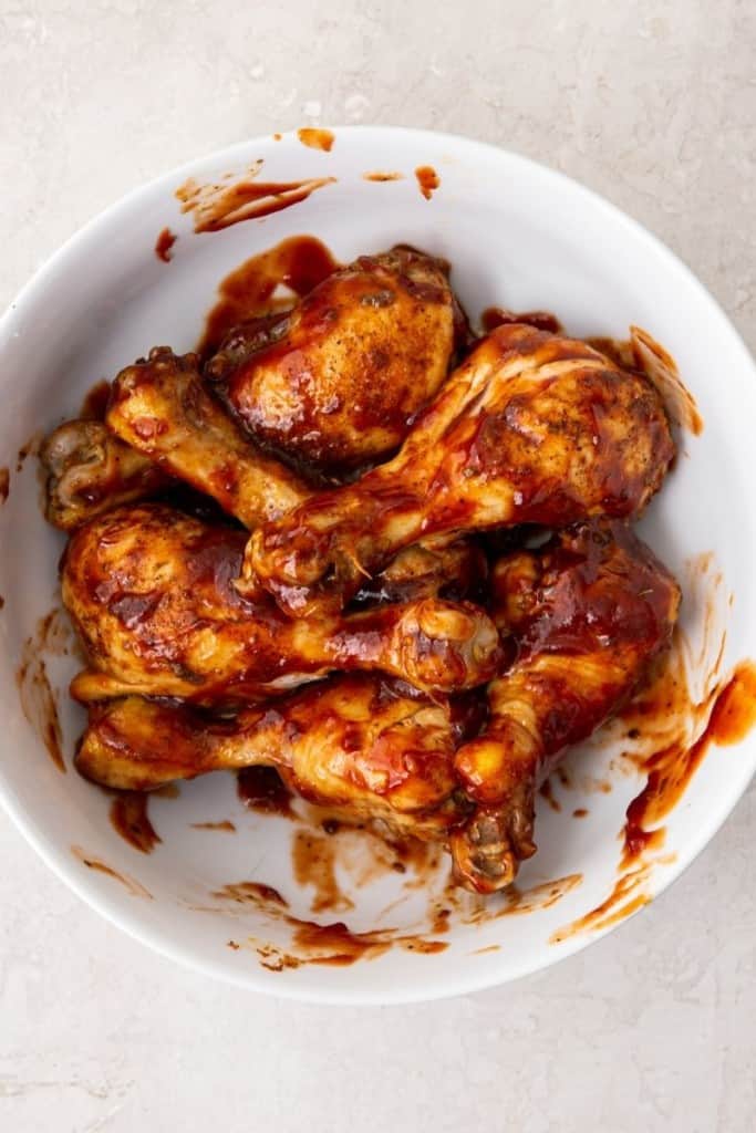 toss cooked chicken drumsticks in bbq sauce and serve