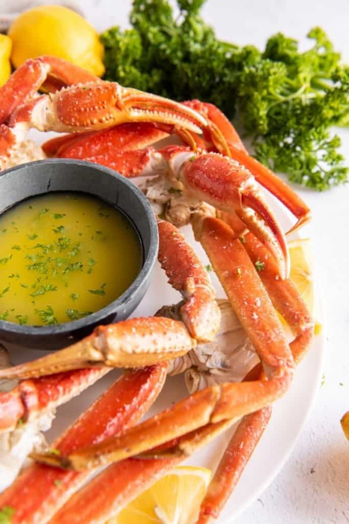 instant pot crab legs placed around garlic butter sauce