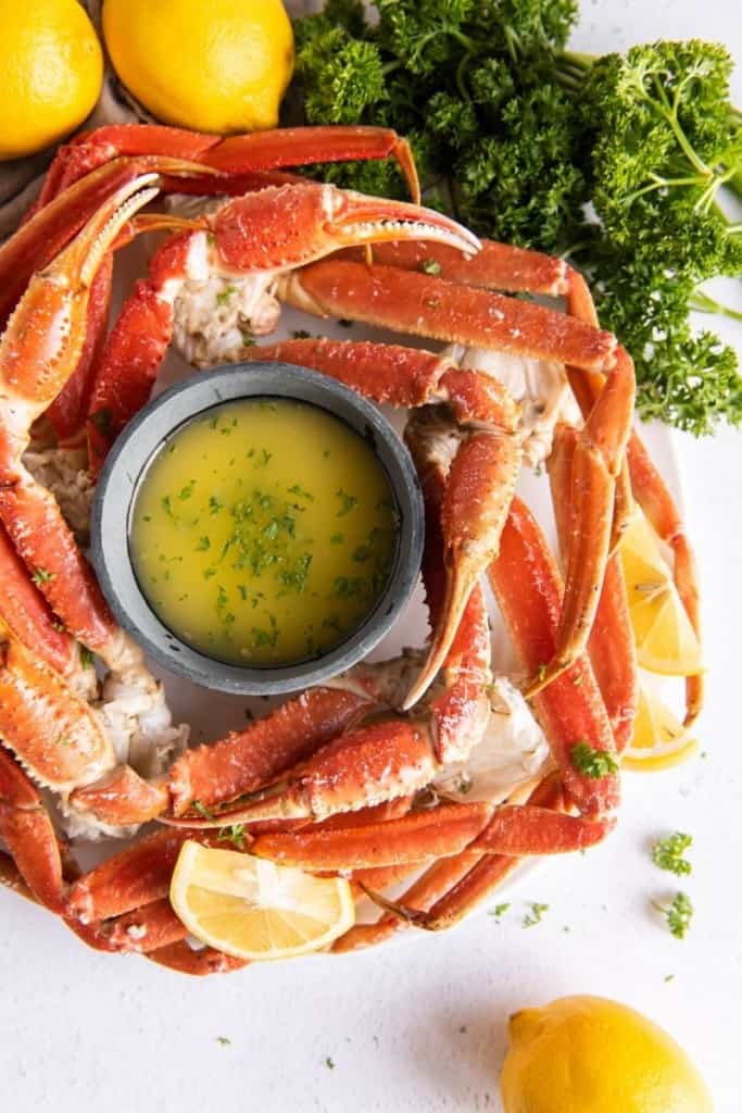 plate with instant pot crab legs and garlic butter sauce