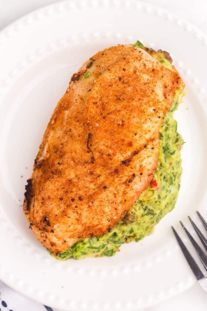 air fryer stuffed chicken breast on white plate with fork