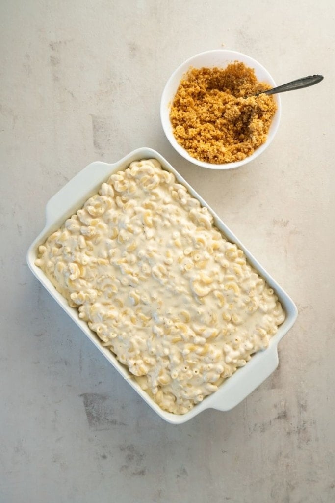 pour sauce and al dente macaroni elbows to casserole dish