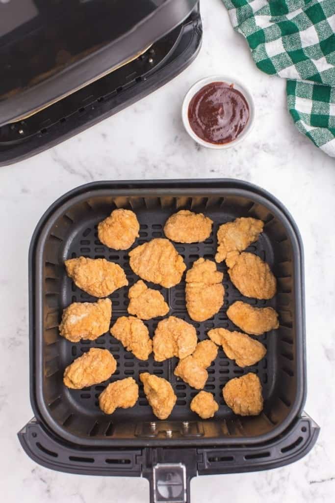 place frozen popcorn chicken pieces in single layer in air fryer