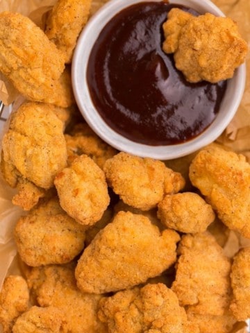 Crunchy popcorn chicken bites with bbq sauce on the side