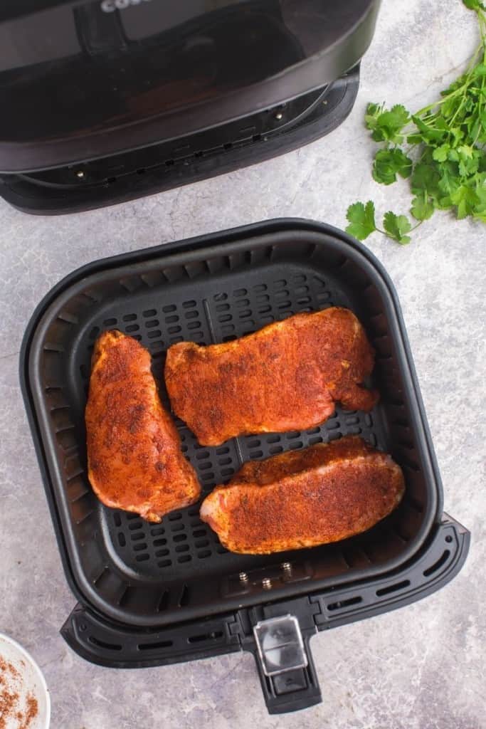 place thick pork chops in air fryer in single layer with room for circulation