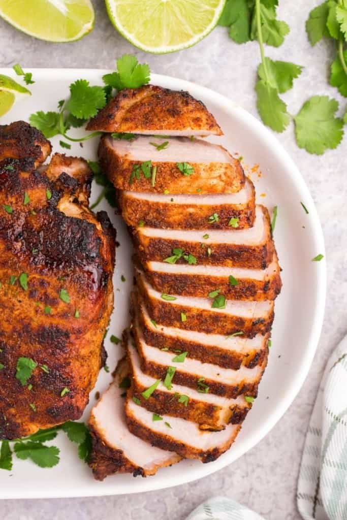 Thick pork chop cooked in air fryer in slices with cilantro lime seasoning