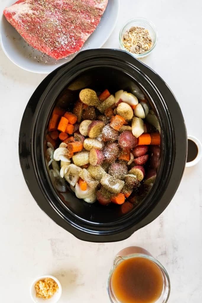 place seasoned vegetables in bottom of crock pot
