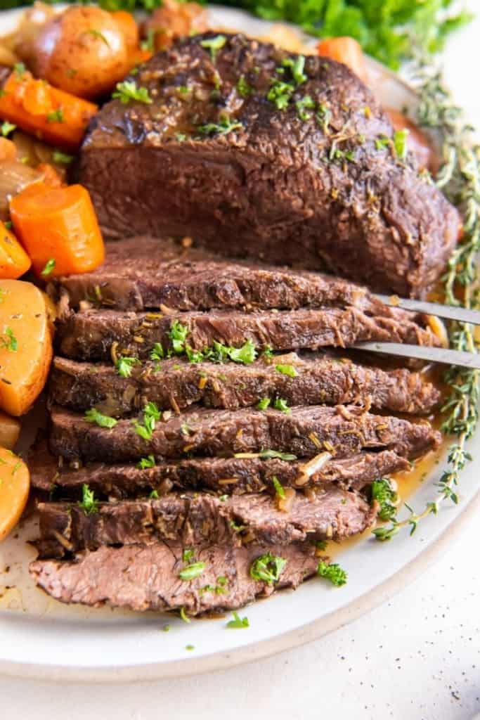 Sliced tri tip cooked in crock pot with vegetables