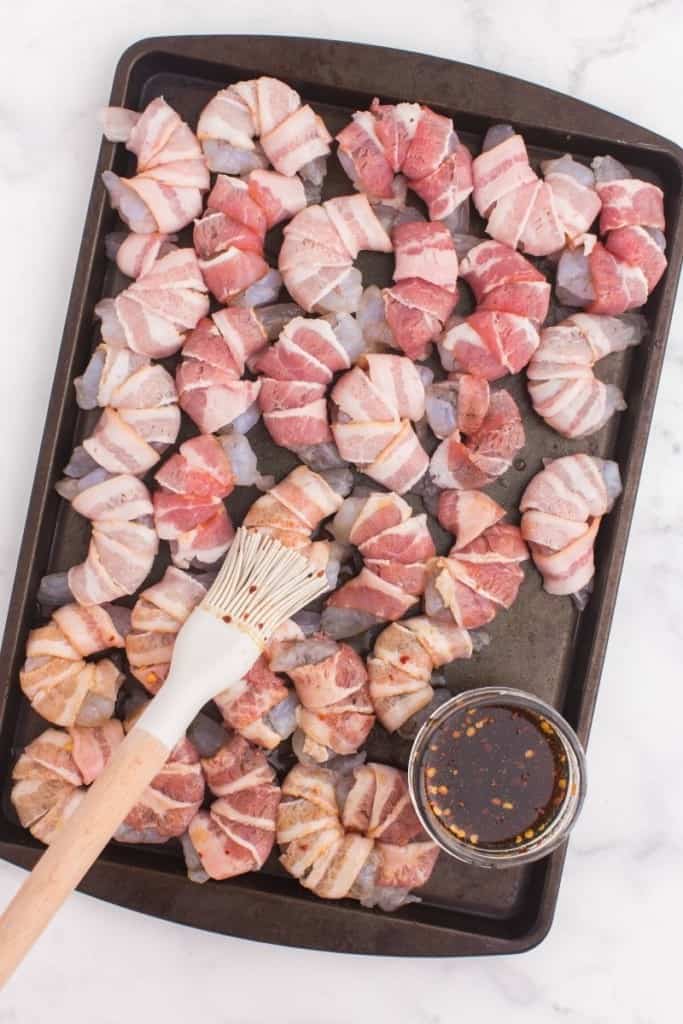 use basting brush to spread glaze over bacon-wrapped shrimp