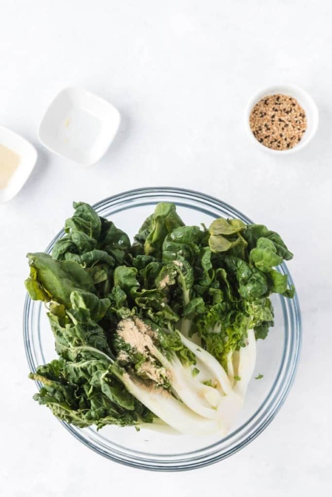 slice bok choy in half, put in bowl, and season