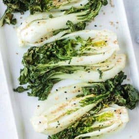 Seasoned air fryer bok choy on white plate