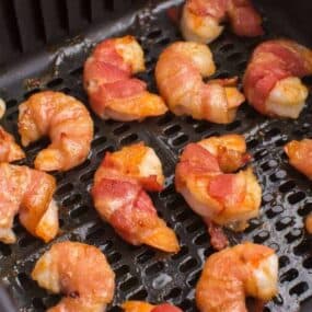 flip bacon-wrapped shrimp, add more glaze, and cook longer