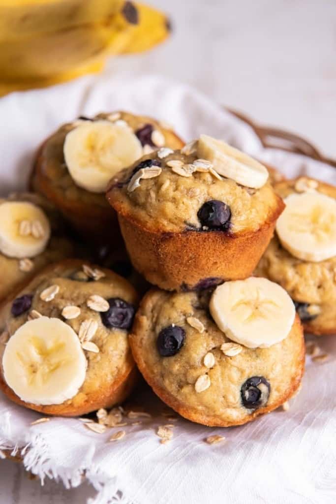 close up of pile of banana blueberry oatmeal muffins