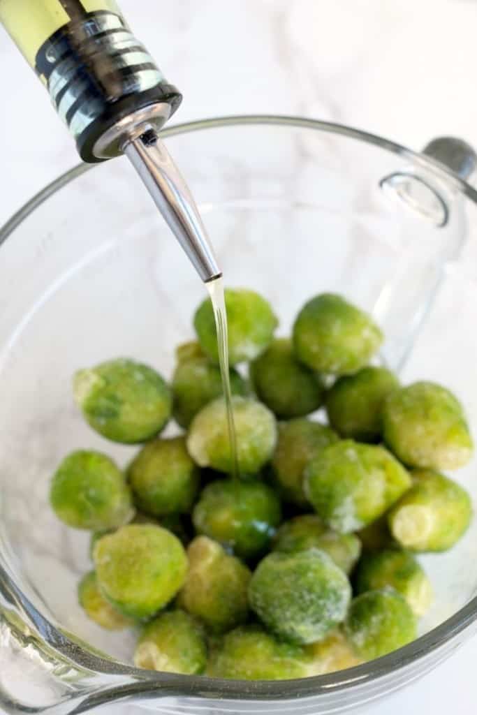 mix frozen brussel sprouts with olive oil, salt, and pepper