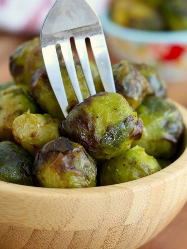 Brussel sprouts cooked in air fryer in bowl with fork