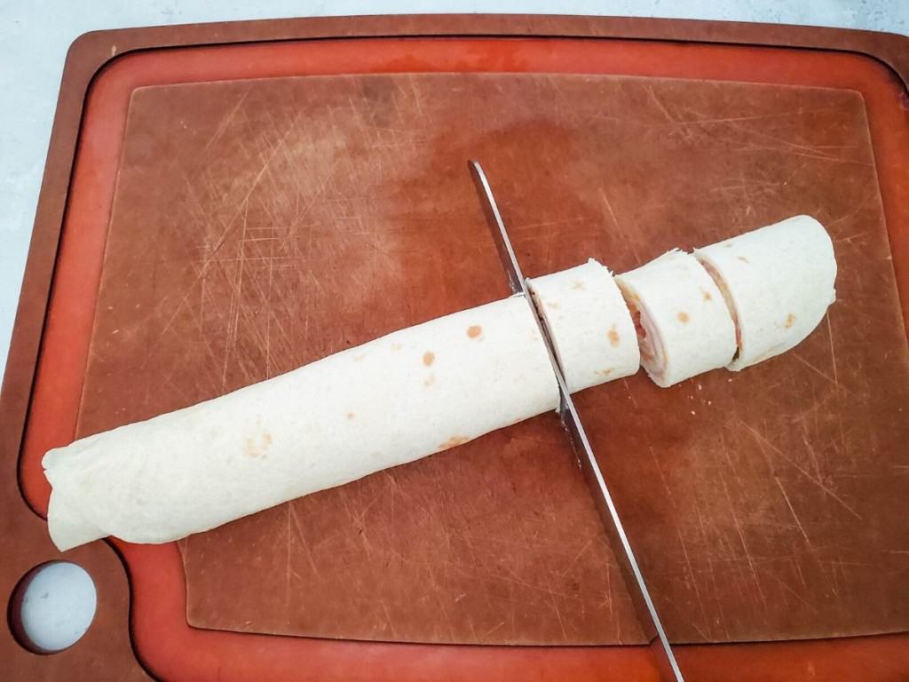 roll up tortilla and cut into individual roll-ups