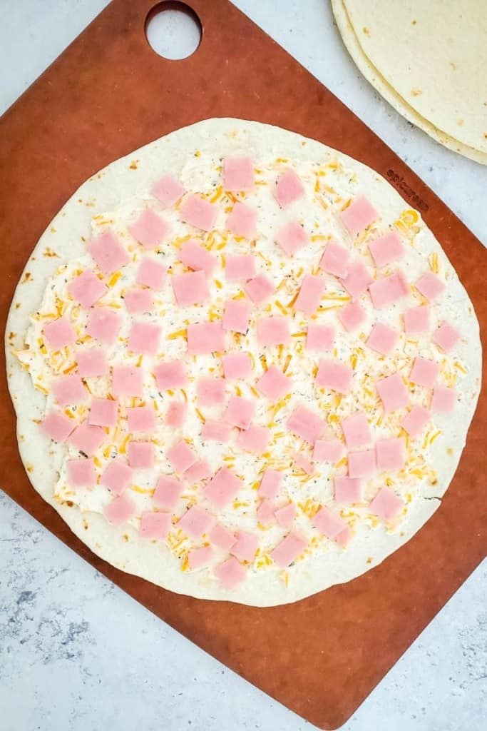 spread cream cheese mixture and place ham pieces on tortillas