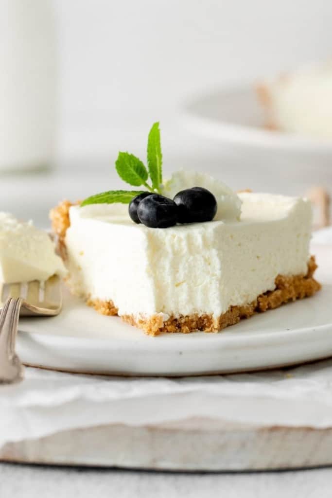 Slice of 5 ingredient no-bake cheesecake with bite taken out of it