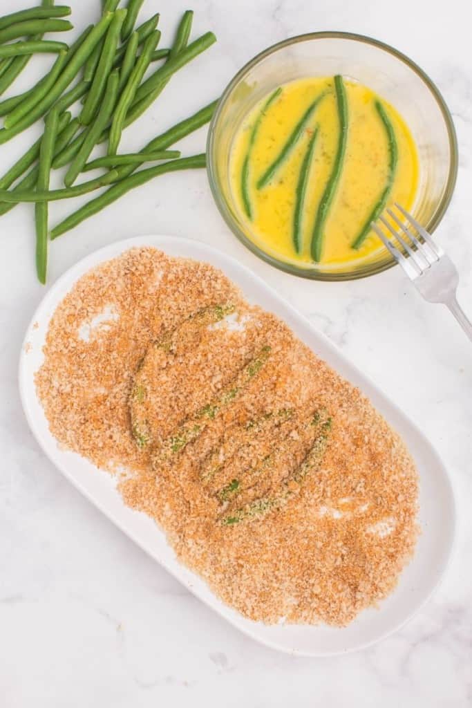 cover green beans in eggs and panko crumb mixture