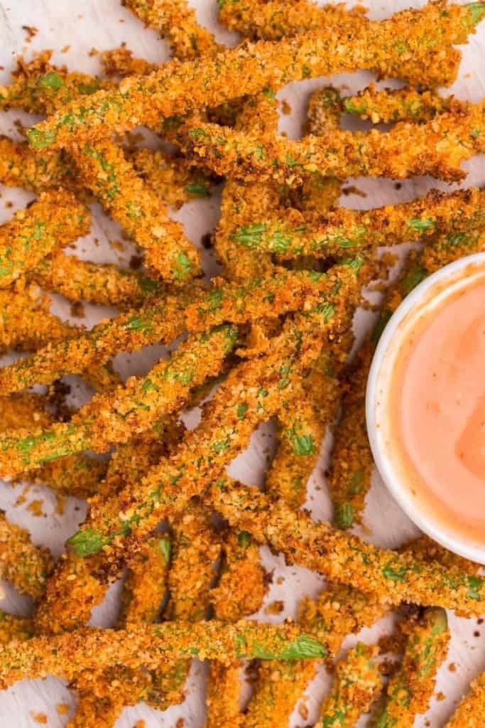 close up of green bean fries on plate with dipping sauce