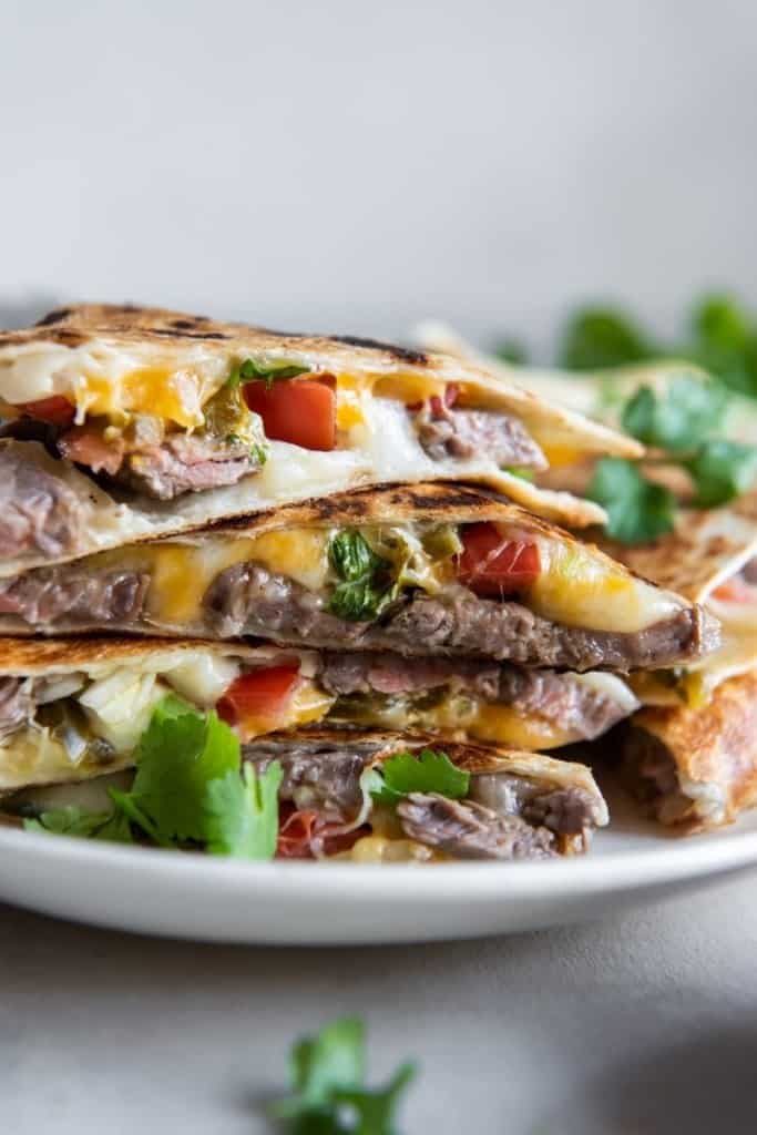 Stack of carne asada quesadillas on plate