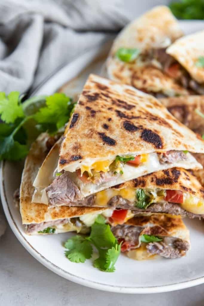 plate with carne asada quesadilla triangles stacked