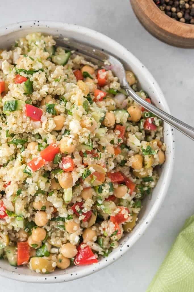 close of white salad bowl full of quinoa salad