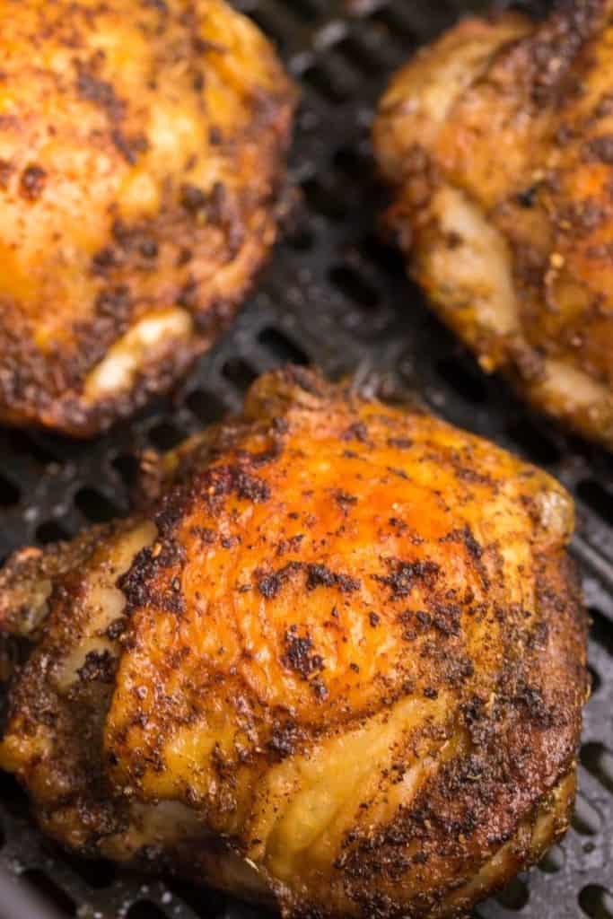 close up of seasoned exterior of air fryer bone in chicken thigh