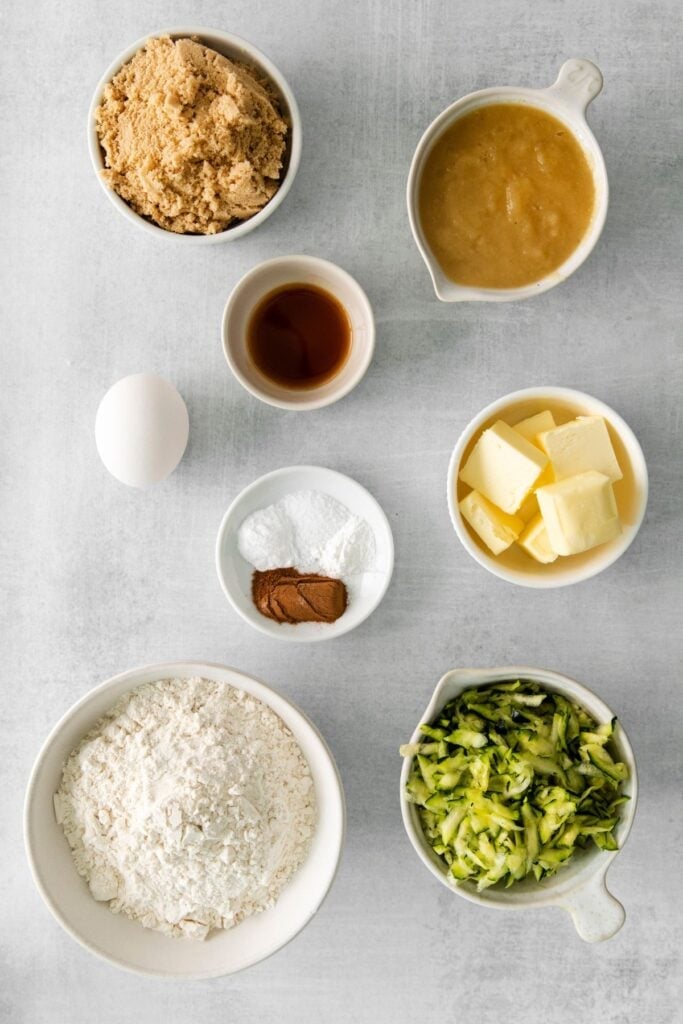 Ingredients needed to make zucchini bread with applesauce.