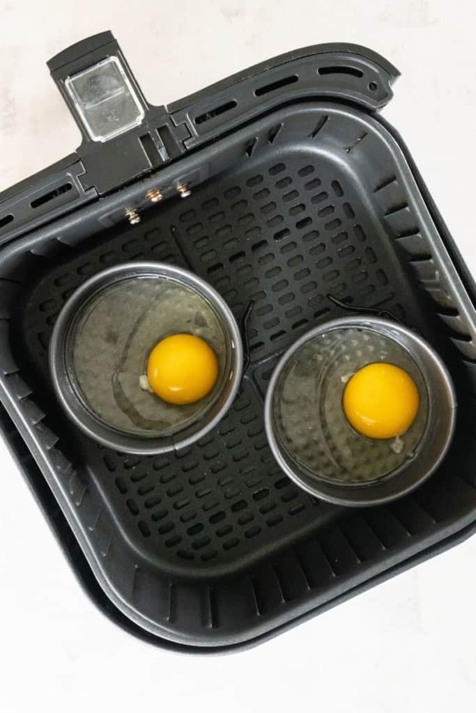crack eggs into small pie tins and place in air fryer